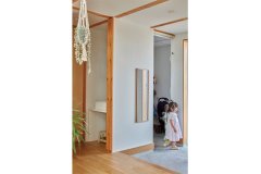 2階の洗面とは別に、玄関横に手洗いを配置。床材はオークの突板、壁は水性塗料仕上げのナチュラルな室内。